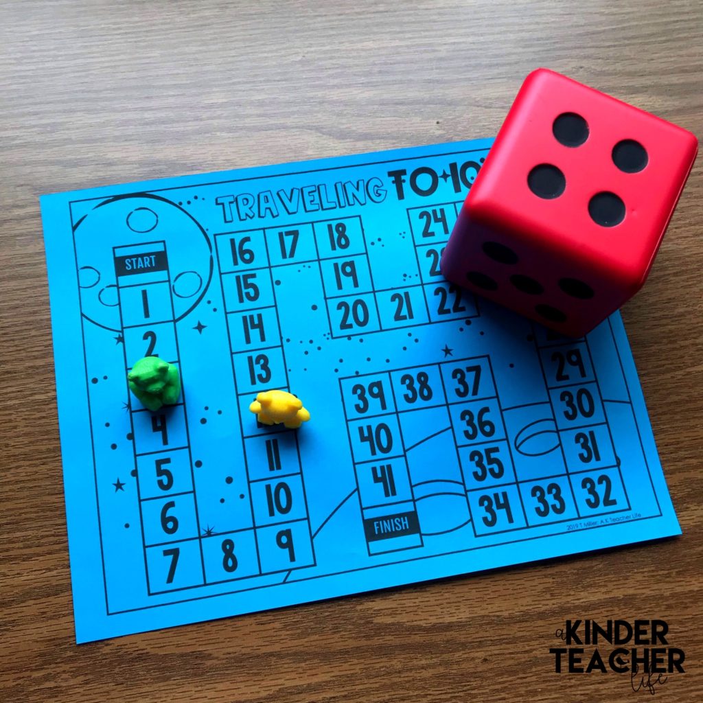 Counting to 100 activity - Students roll the die and move that many spaces. Then, they say the number number that comes before and after the number they land on. 